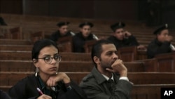 FILE - Dec. 4, 2014 photo, Mahienour el-Masry, left, during a trial of activists, in Cairo, Egypt. Egyptian authorities released three activists including el-Masry, and three journalists July 18, 2021.
