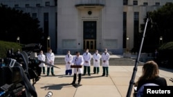 U.S. Navy Commander Dr. Sean Conley, the White House physician, is flanked by other doctors as he speaks to the media, at Walter Reed National Military Medical Center in Bethesda, Maryland, Oct. 4, 2020.