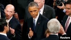 U.S. President Barack Obama gives a thumbs up to Secretary of State John Kerry (R) as he departs after concluding his State of the Union address to a joint session of the U.S. Congress on Capitol Hill, Jan. 20, 2015. 