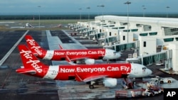 FILE - AirAsia Airbus A320-200 passenger jets are parked on the tarmac at low-cost terminal KLIA2 in Sepang, Malaysia, Nov. 10, 2014. 