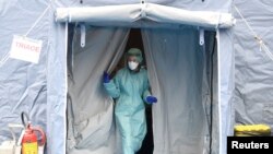 A medical worker wearing protective mask is seen at a medical checkpoint at the entrance of the Spedali Civili hospital in Brescia, Italy, March 3, 2020.