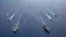 FILE - In this photo provided by U.S. Navy, the USS Ronald Reagan (CVN 76) and USS Nimitz (CVN 68) Carrier Strike Groups steam in formation, in the South China Sea, July 6, 2020.