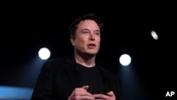 Tesla CEO Elon Musk speaks before unveiling the Model Y at the company's design studio in Hawthorne, California, March 14, 2019.
