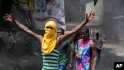 People protest against the assassination of Haitian President Jovenel Moïse near the police station of Petion Ville in Port-au-Prince, Haiti, July 8, 2021.