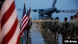 US Army paratroopers prepare equipment and load aircraft at Fort Bragg, N.C. on Jan. 4, 2020. This Pentagon said their deployment is a response to increased threats against US personnel and facilities.