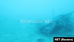 FILE - Debris, believed to be from Lion Air flight JT610 plane, which crashed, is seen during an operation by Navy divers near the search area off Tanjung Pakis, Indonesia, Oct. 31, 2018, in this still image taken from a video obtained from social media. 