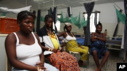 Pregnant women watch television as they wait in the pre-natal ward at Princess Christian Maternity Hospital in Freetown, Sierra Leone, September 10, 2010.