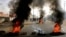 Sudanese protesters use burning tires to erect a barricade on a street, demanding that the country's Transitional Military Council hand over power to civilians, in Khartoum, Sudan, June 3, 2019.