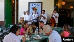 Tourists dine at La Mina state restaurant in Old Havana, Cuba, Dec. 18, 2014. Many Cubans have welcomed President Barack Obama's policy shift, anticipating more tourism and other business.