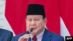 This photo provided on Nov. 8, 2024, by the Presidential Palace shows Indonesian President Prabowo Subianto speaking to the press at Halim Perdanakusuma Air Base in Jakarta before departing for his visit to Beijing.