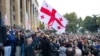 Supporters of the ex-President Mikhail Saakashvili's United National Movement, wave Georgian national flags during rally to protest the election results rally in front of the parliament's building in Tbilisi, Georgia, Nov. 1, 2020.