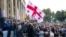 Supporters of the ex-President Mikhail Saakashvili's United National Movement, wave Georgian national flags during rally to protest the election results rally in front of the parliament's building in Tbilisi, Georgia, Nov. 1, 2020.