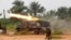 FILE - Democratic Republic of Congo soldiers are seen launching missiles during their military operation against ADF rebels outside the town of Beni, in North Kivu province, Jan. 18, 2014.