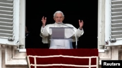 Pope Benedict waves as he leads his last Sunday prayers at the Vatican February 24, 2013.