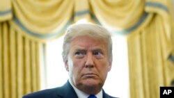 FILE - A Dec. 7, 2020, photo of President Donald Trump in the Oval Office of the White House in Washington. 