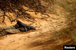 The body of a dead migrant lies in a desert area outside Sunland Park, New Mexico, on Aug. 17, 2023.