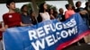 FILE - Activists hold a banner during a demonstration organized by HIAS, founded as the Hebrew Immigrant Aid Society, outside the U.S. Capitol in Washington, Sept. 14, 2017. HIAS, the Jewish nonprofit singled out by the Pittsburgh synagogue assailant, is one of a number of religious-affiliated groups in the United States that provide help to refugees.