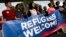 FILE - Activists hold a banner during a demonstration organized by HIAS, founded as the Hebrew Immigrant Aid Society, outside the U.S. Capitol in Washington, Sept. 14, 2017. HIAS, the Jewish nonprofit singled out by the Pittsburgh synagogue assailant, is one of a number of religious-affiliated groups in the United States that provide help to refugees.