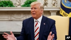 President Donald Trump speaks during a meeting with Romanian President Klaus Iohannis in the Oval Office of the White House.