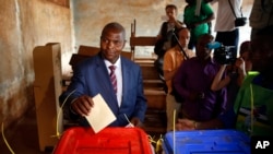 FILE - Former Prime Minister Faustin Archange Touadera casts his ballot in the second round of presidential election and the first round of legislative elections in Bangui, Central African Republic, Feb. 14, 2016. Touadera was declared winner of the election Feb. 20.