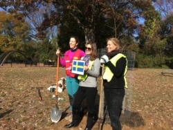 Eva Hunnius Ohlin, right, senior adviser for energy and environment at the Swedish Embassy, with two of her colleagues insisted on Swedish sovereignty in their planting effort. (Natalie Liu/VOA)