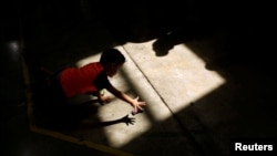 FILE - A migrant boy plays at a migrant shelter run by the federal government in Ciudad Juarez, Mexico, Sep. 26, 2019. 
