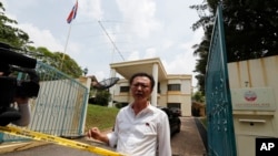 A North Korean embassy employee asks police if staff are allowed to leave as police put a cordon at the embassy in Kuala Lumpur, Malaysia, March 7, 2017.