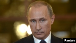 FILE - Russia's President Vladimir Putin talks to reporters.