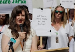 FILE - Emily Cunningham, left, who works at Amazon.com, speaks as Kathryn Dellinger, right, who also works for Amazon, looks on, May 22, 2019, in Seattle. Both women are part of the group "Amazon Employees for Climate Justice."