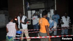 People line up to receive home disinfectant kits from Doctors Without Borders to prevent Ebola in Monrovia, Liberia, Oct. 20, 2014.