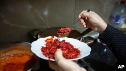 Chahida Boufaied, owner of Dar Chahida Lel Oula, prepares the Harissa in her house in Nabeul, Tunisia, Jan. 7, 2025.