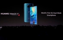 FILE - Richard Yu, CEO of the Huawei consumer business group, presents new devices during an event in Munich, Germany, Sept. 19, 2019.