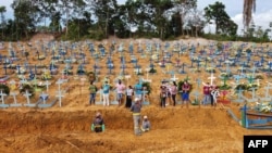 This aerial photo shows a burial at an area where new graves have been dug at the Nossa Senhora Aparecida cemetery in Manaus in the Amazon forest in Brazil, on April 22, 2020.