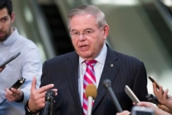 FILE - Democratic Sen. Bob Menendez speaks with the media on Capitol Hill in Washington, March 5, 2019.