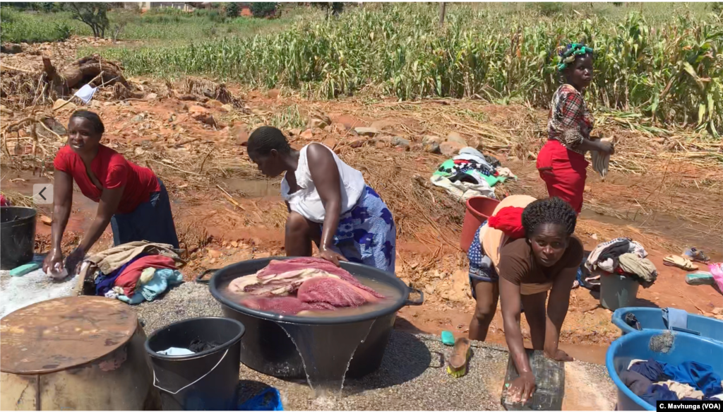 Woman in Ngunga area in Chimanimani use open water sources March 26, 2019, for household chores. The United Nations fears waterborne diseases will erupt in Chimanimani district after Cyclone Idai destroyed most water pipes.