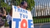 Hugh Kieve, 10, of Washington, holds a sign outside the White House in Washington, SJuly 21, 2024, as he and his family come out to show support for President Joe Biden.