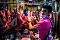 A vendor sells meat at Khlong Toei wet market despite fears of the spread of the COVID-19 coronavirus in Bangkok on April 14, 2020.