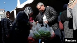 People shop at a tent set up by the municipality in the Bayrampasa district of Istanbul, Turkey, Feb. 11, 2019.