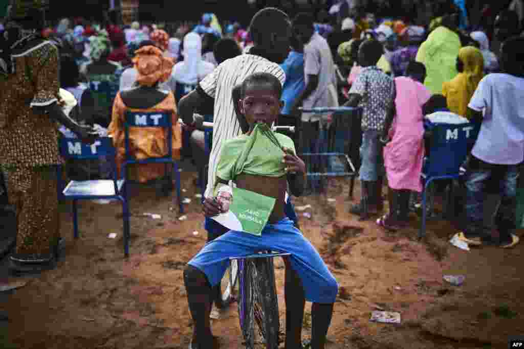 A young boy holds a flyer of Malian opposition candidate for the presidential elections Soumaila Cisse during a rally in Koulikoro. Mali's incumbent president Ibrahima Boubacar Keita, who took office in 2013, and opposition frontrunner Soumaila Cisse are expected to be the two main candidates in the July 29 polls out of a field of 24 hopefuls