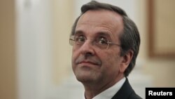 Newly appointed Greek Prime Minister Antonis Samaras smiles before a swearing in ceremony at the presidential palace in Athens, June 20, 2012. 