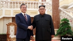 South Korean President Moon Jae-in shakes hands with North Korean leader Kim Jong Un as they arrive for their meeting at the headquarters of the Central Committee of the Workers' Party of Korea in Pyongyang, North Korea, September 18, 2018.