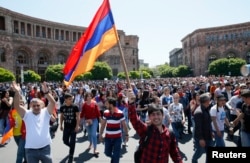 Armenian opposition supporters walk on the street after protest movement leader Nikol Pashinyan announced a nationwide campaign of civil disobedience in Yerevan, Armenia, May 2, 2018.