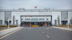 Police officers stand at the entrance of the Urumqi No. 3 Detention Center in Dabancheng in China's Xinjiang Uyghur Autonomous Region on April 23, 2021. Urumqi No. 3 is China's largest detention center and has room for at least 10,000 prisoners. (AP Photo/Mark Schiefelbein, File)