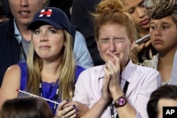 Supporters watch the election results during Democratic presidential nominee Hillary Clinton's election night rally in the Jacob Javits Center glass enclosed lobby in New York, Nov. 8, 2016.