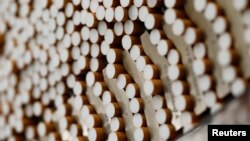 FILE - Cigarettes are seen during the manufacturing process in the British American Tobacco Cigarette Factory (BAT) in Bayreuth, southern Germany, April 30, 2014. 