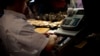 A man uses a cash register at a market in Madrid, Spain, Aug. 13, 2013. 