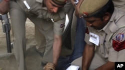 Indian police detain a Tibetan exile participating in an illegal protest against the visit of Chinese President Hu Jintao in New Delhi, India, March 28, 2012. 