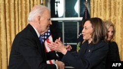 US President Joe Biden and Vice-President Kamala Harris go for a hug as Second Gentleman Doug Emhoff looks on after the President delivered his farewell address to the nation from the Oval Office of the White House in Washington, DC, on January 15, 2025. 