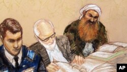 A sketch by a courtroom artist shows self-proclaimed terrorist mastermind Khalid Sheikh Mohammed, right, as he reviews court documents with his lawyers during the pre-trial hearing at the Guantanamo Bay U.S. Naval Base in Cuba, Feb. 12, 2013.