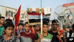 FILE - Thousands of Iraqis braved the scorching summer heat to stage the protest against government corruption in Tahrir Square in Baghdad, Aug. 7, 2015.
